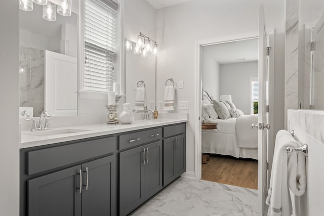 bathroom featuring a tile shower, vanity, a wealth of natural light, and wood-type flooring