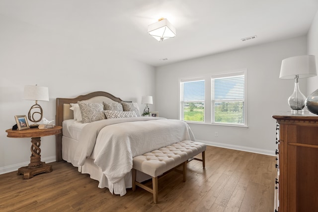 bedroom with dark hardwood / wood-style flooring