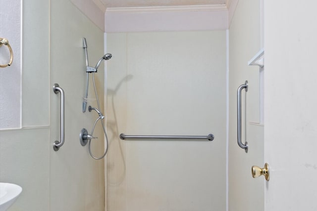 bathroom featuring ornamental molding and walk in shower