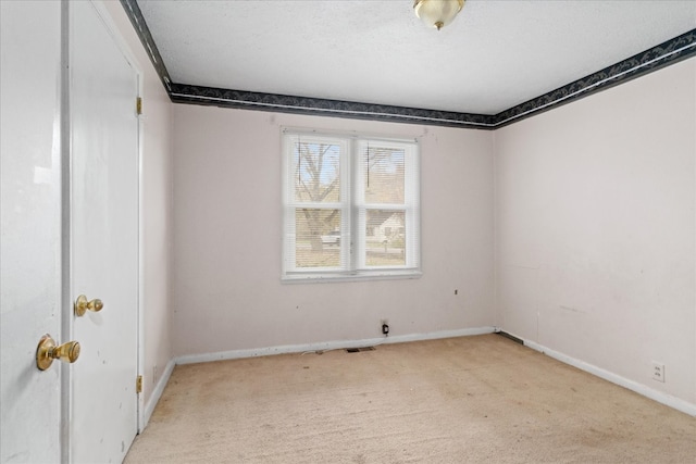 carpeted spare room featuring a textured ceiling