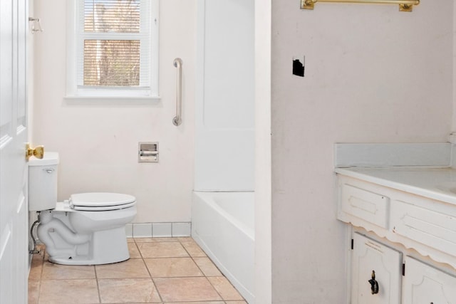 bathroom with tile patterned flooring, vanity, toilet, and a washtub