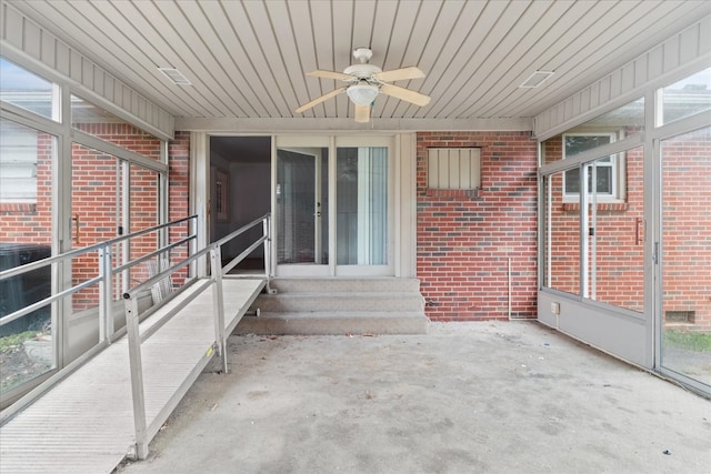 unfurnished sunroom featuring ceiling fan and wood ceiling