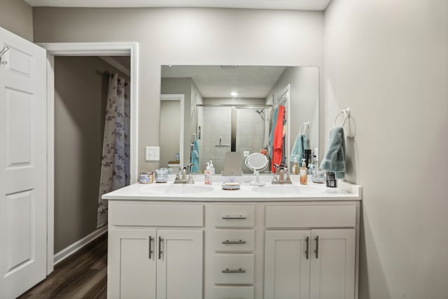 bathroom featuring walk in shower, vanity, and hardwood / wood-style flooring