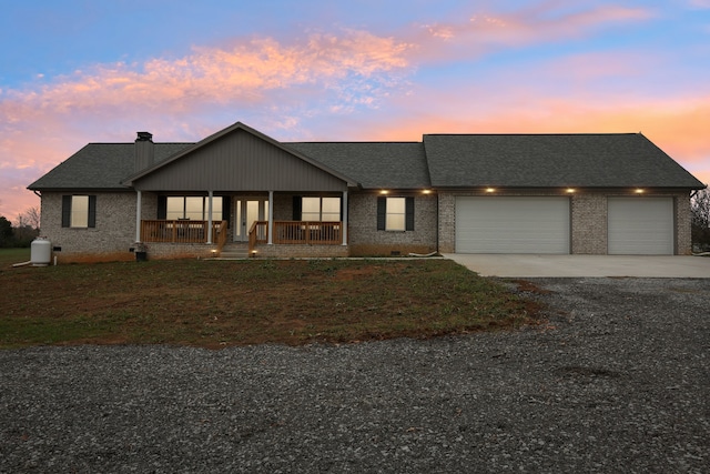 view of front of property featuring a porch and a garage