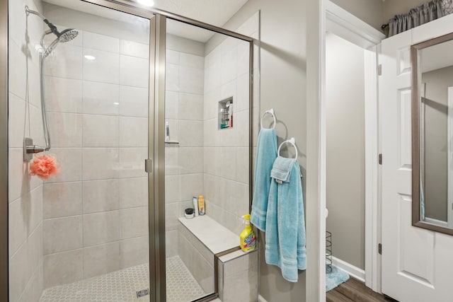 bathroom featuring wood-type flooring and walk in shower