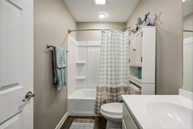 full bathroom with a textured ceiling, toilet, vanity, shower / tub combo, and hardwood / wood-style flooring