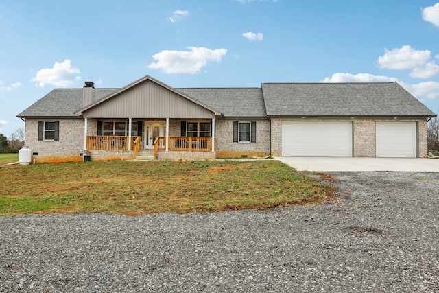 ranch-style home with a front lawn, a porch, and a garage