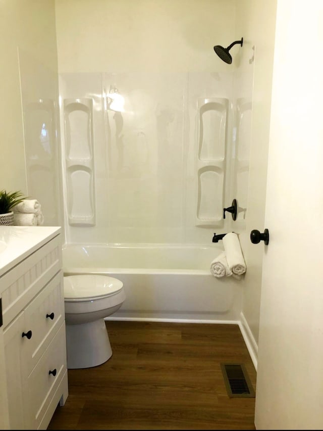 full bathroom featuring bathtub / shower combination, hardwood / wood-style floors, vanity, and toilet