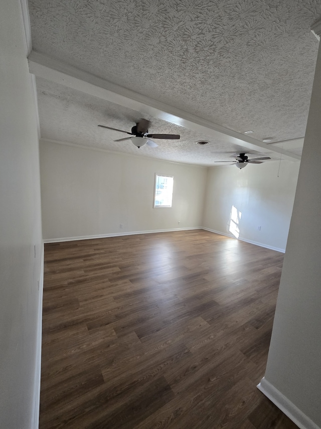 spare room with a textured ceiling and dark wood-type flooring