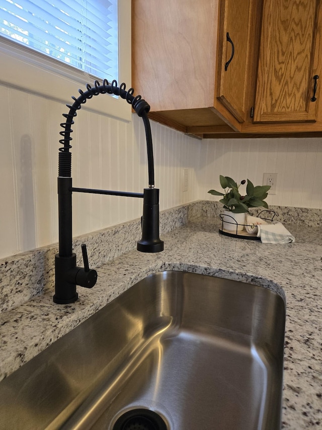 interior details with light stone countertops and sink