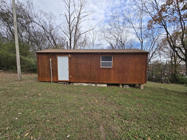 view of outbuilding featuring a yard