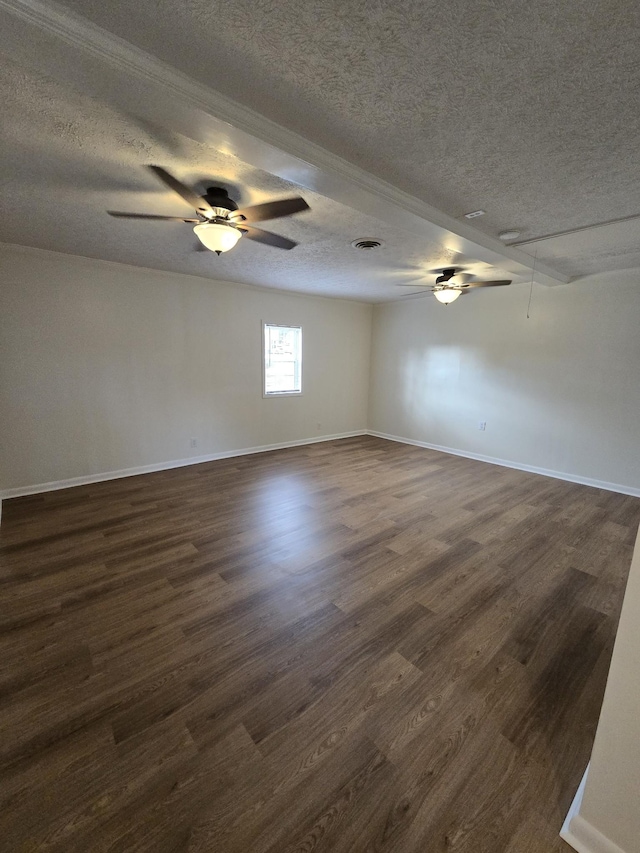 empty room with a textured ceiling and dark wood-type flooring