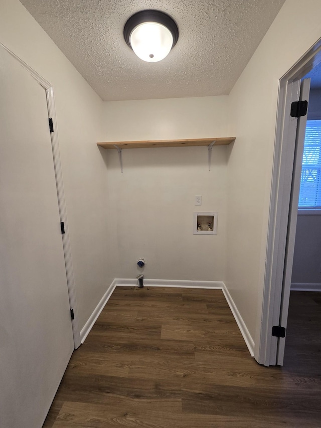 clothes washing area with a textured ceiling, washer hookup, and dark hardwood / wood-style floors