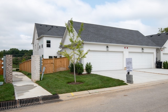 view of front facade with a garage and a front lawn