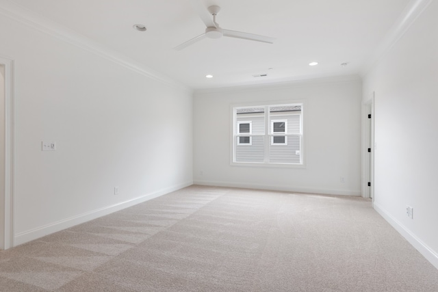 spare room with crown molding, ceiling fan, and light colored carpet