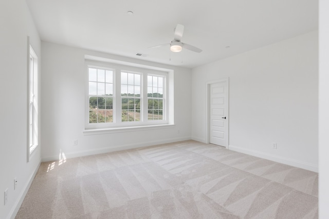 empty room featuring light carpet and ceiling fan