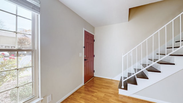 entrance foyer featuring light wood-type flooring and a healthy amount of sunlight