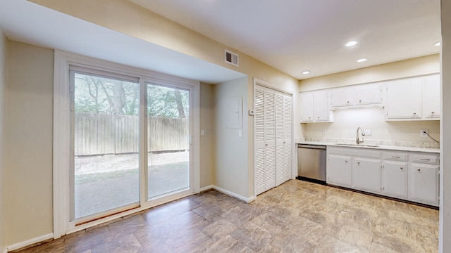 kitchen featuring light stone countertops, white cabinetry, sink, and stainless steel dishwasher