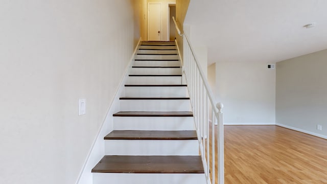 staircase featuring wood-type flooring