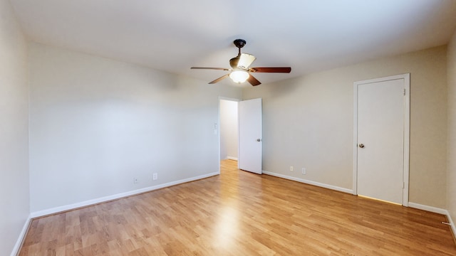 empty room with ceiling fan and light hardwood / wood-style flooring