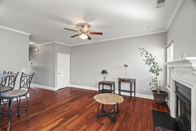 living room featuring wood-type flooring, ceiling fan, and ornamental molding