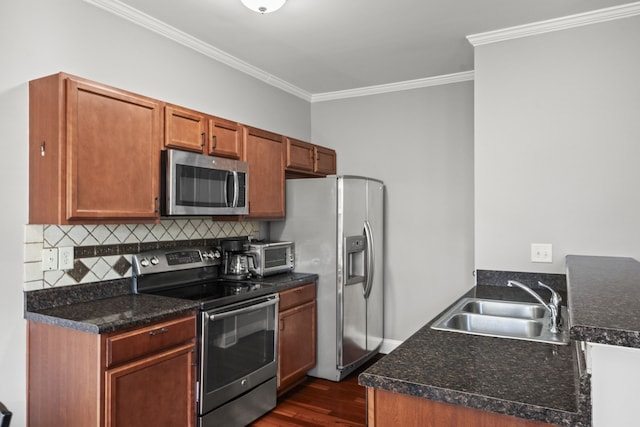 kitchen featuring dark hardwood / wood-style flooring, stainless steel appliances, crown molding, and sink