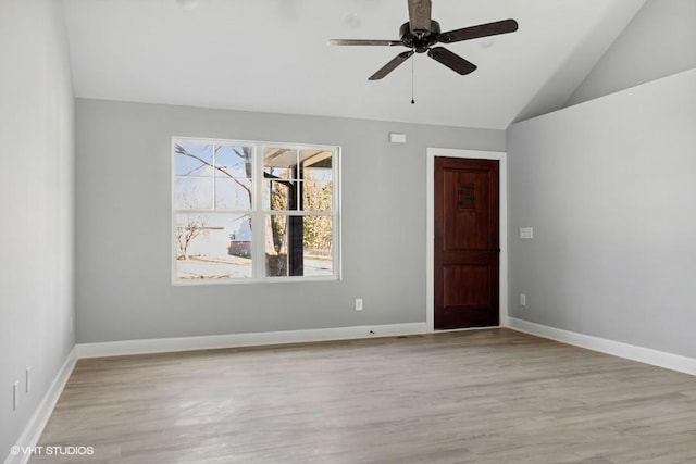 spare room with ceiling fan, lofted ceiling, and light hardwood / wood-style flooring