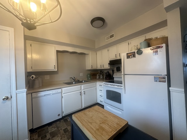 kitchen featuring white appliances, white cabinets, sink, decorative light fixtures, and a chandelier