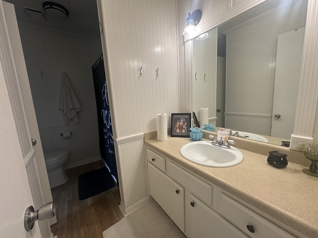 bathroom with vanity, wood-type flooring, and toilet