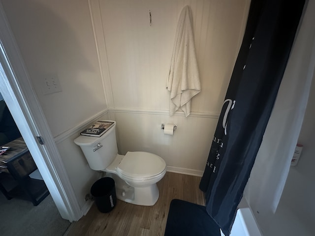 bathroom featuring wood-type flooring and toilet