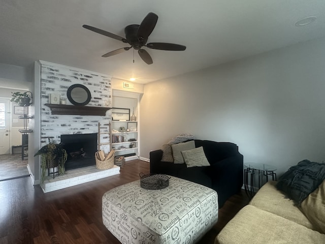 living room with ceiling fan, a fireplace, and dark hardwood / wood-style floors