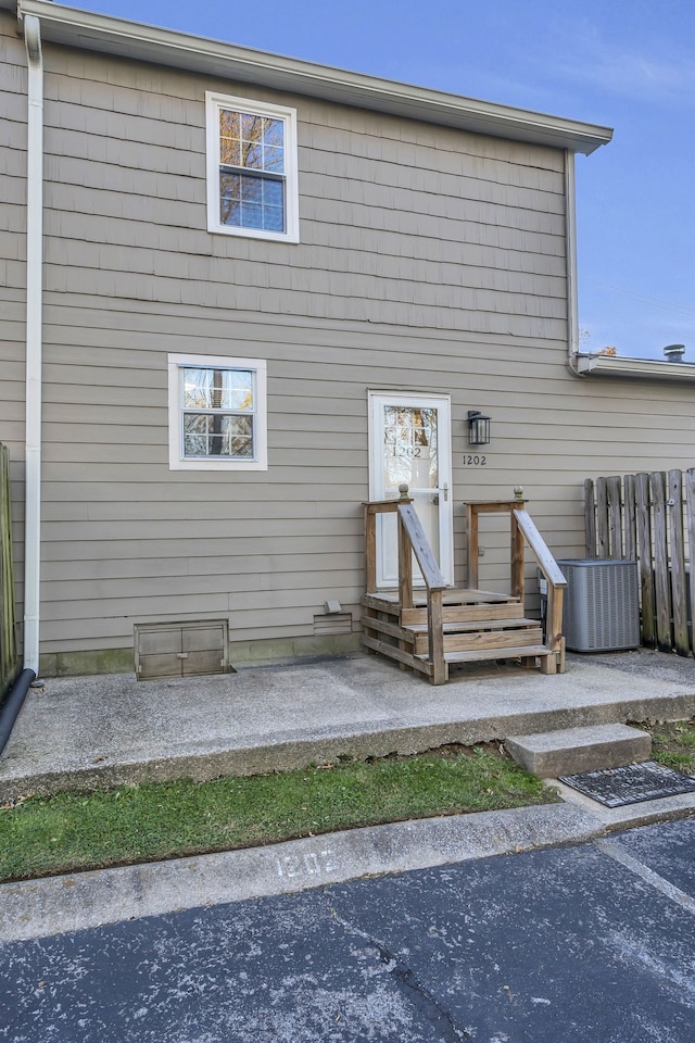 rear view of property featuring central AC