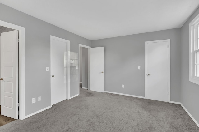 unfurnished bedroom with carpet floors