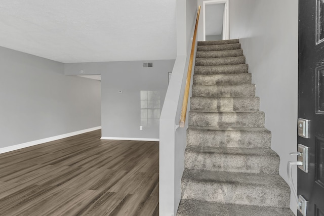 stairs with hardwood / wood-style floors