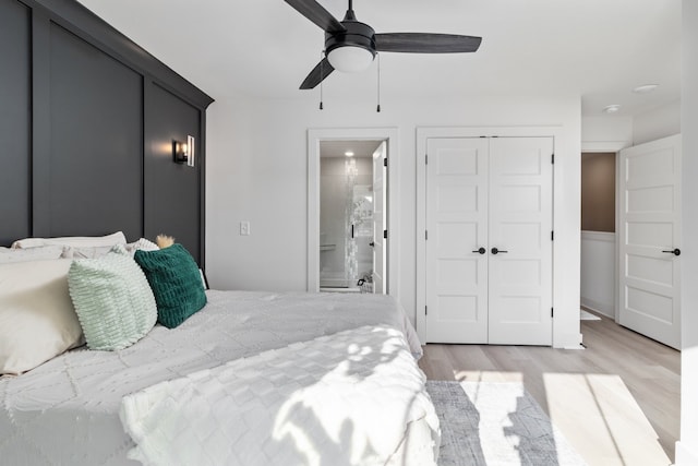 bedroom featuring ensuite bathroom, ceiling fan, and light wood-type flooring