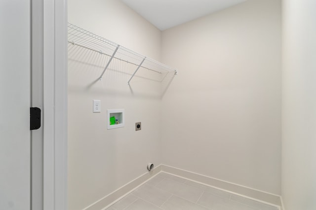 laundry area with electric dryer hookup, light tile patterned flooring, and hookup for a washing machine