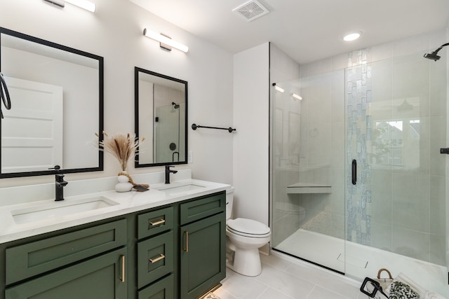 bathroom featuring tile patterned flooring, vanity, toilet, and walk in shower