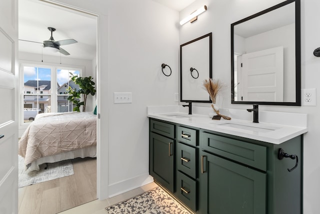 bathroom featuring hardwood / wood-style floors, vanity, and ceiling fan