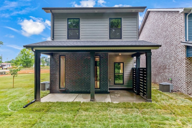 back of house with a yard and central AC unit