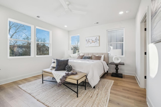 bedroom with ceiling fan and light wood-type flooring