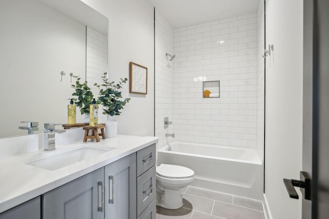 full bathroom with vanity, toilet, tile patterned floors, and tiled shower / bath combo