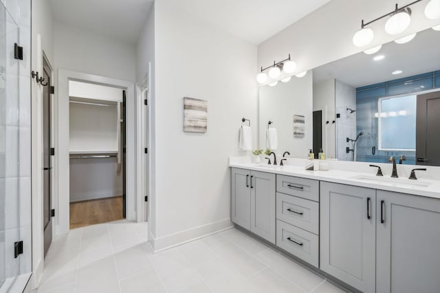 bathroom with tile patterned flooring, walk in shower, and vanity