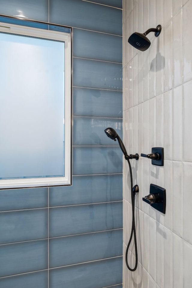 interior details featuring a tile shower