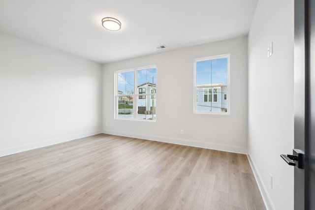 spare room featuring light hardwood / wood-style flooring