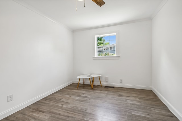 empty room featuring wood-type flooring, ceiling fan, and ornamental molding