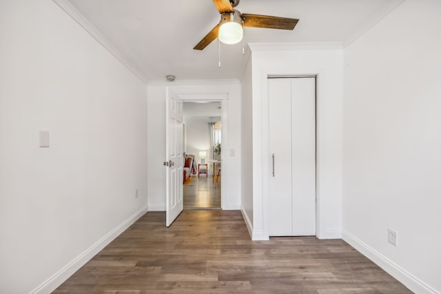 corridor featuring crown molding and wood-type flooring