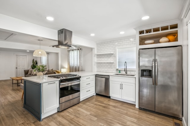 kitchen with white cabinetry, sink, island exhaust hood, appliances with stainless steel finishes, and light wood-type flooring