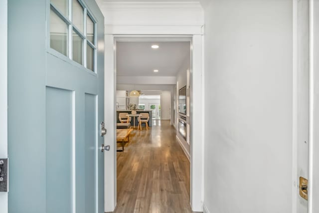 corridor with hardwood / wood-style flooring