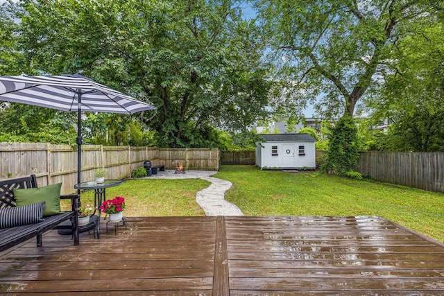 wooden deck featuring a storage unit and a yard