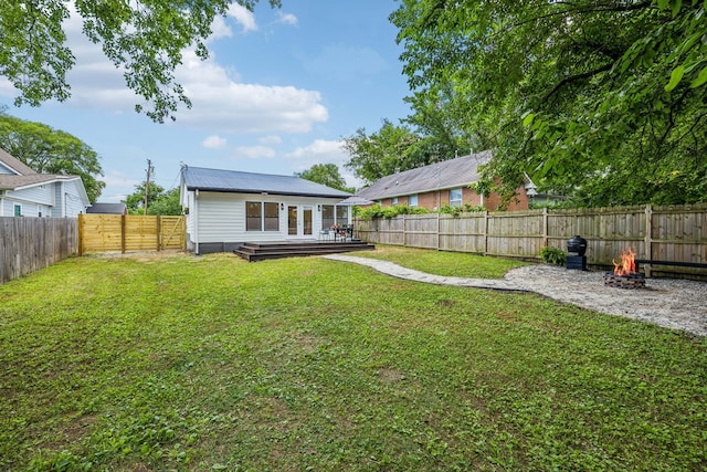 view of yard featuring a deck and an outdoor fire pit